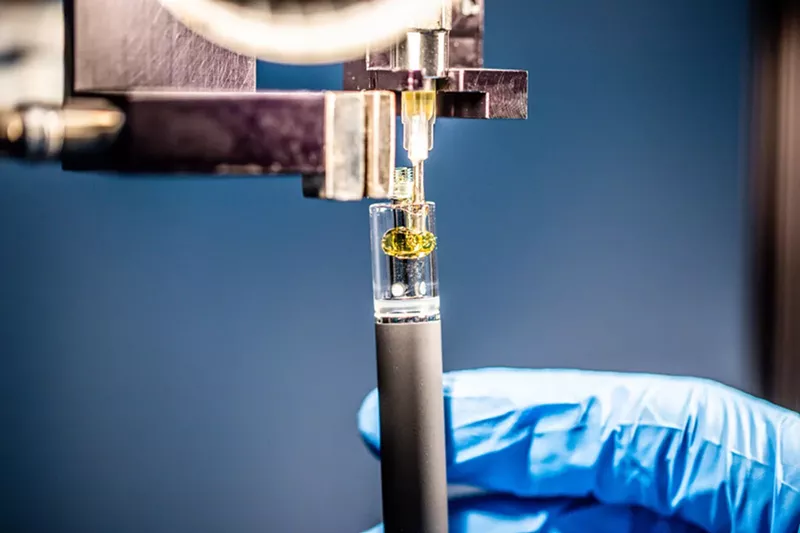 A disposable vape being filled with cannabis oil. - Shutterstock